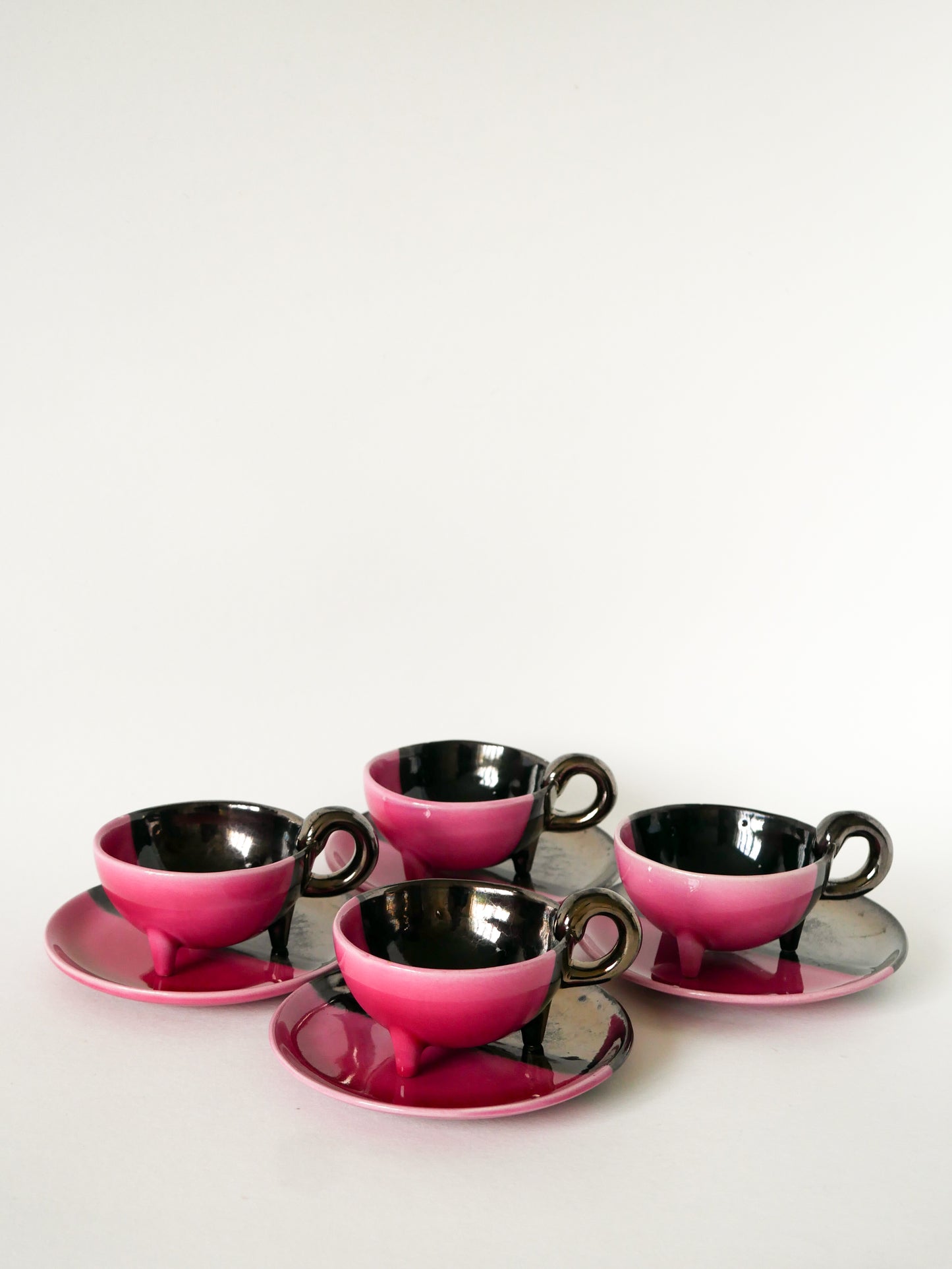 Duo de tasses tripodes et soucoupes Vallauris en céramique bicolore, Rose et Noir Irisé, 1970